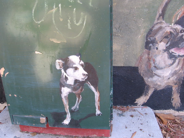 Painted dog on a utility box seems to have jumped out from the bustling mural.