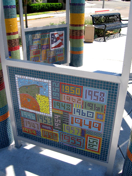 Closer photo of The Lookout at Legacy Park. Eight mosaic panels made of tile show historical events in La Mesa from 1912 to 2012.