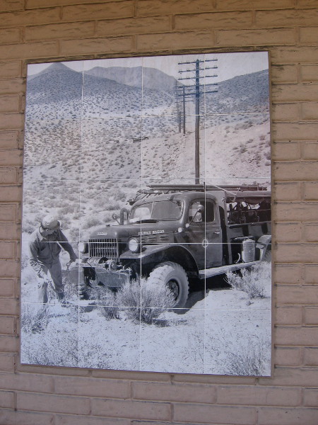 Old photo on ATT building shows telephone company worker in the undeveloped hills of La Mesa many years ago.