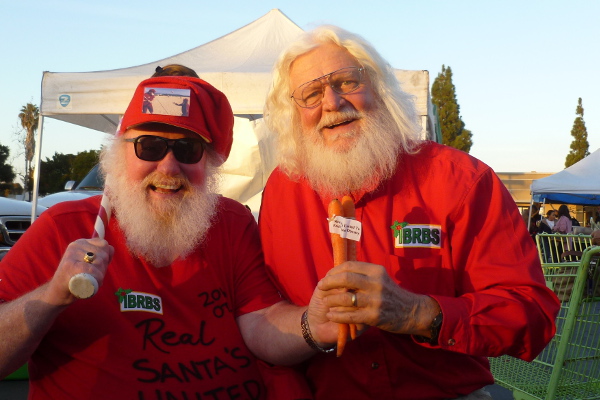 Photo of Baseball Santa Bill Swank and Richard “Sustainable Santa” Eckfield at the Linda Vista Farmers Market last December. Photo courtesy Bill Swank.