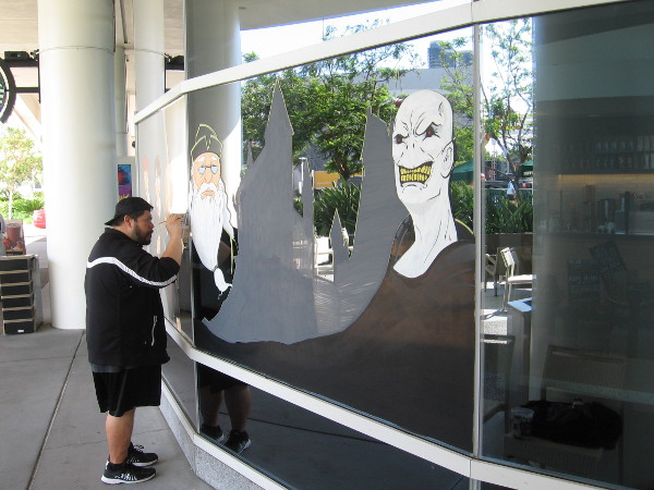 Artist paints Harry Potter characters in windows of the Hilton Bayfront Starbucks.