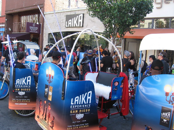 Lots of pedicabs on Fifth Avenue promoting the Laika Experience are in front of that cool exhibit.