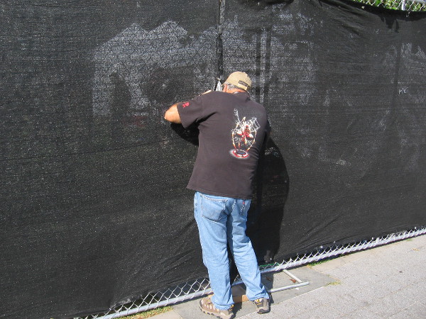 This guy is secretly peering through the fence, perhaps hoping to see zombies.