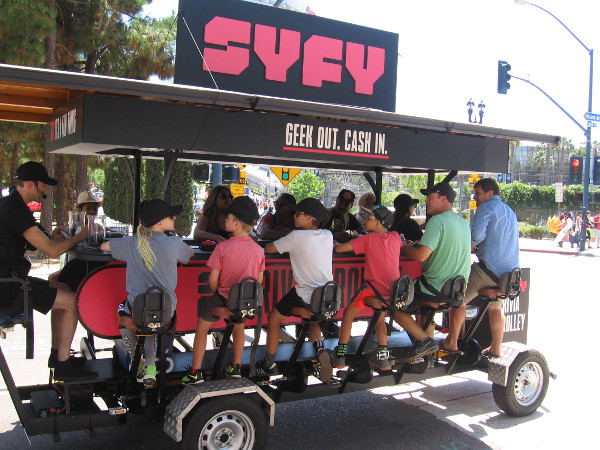 People peddle the Syfy Trivia Trolley while answering questions for prizes!