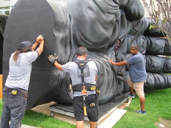 Workers push a gigantic ape hand into position. This will be part of Kong Skull Island, an outdoor San Diego Comic-Con site next to the Omni Hotel.