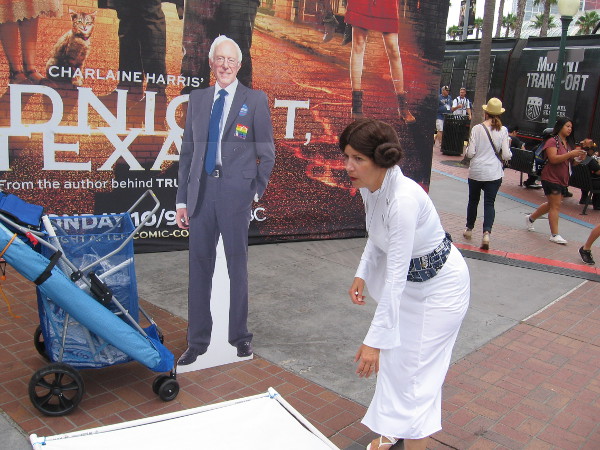 Princess Leia sets up a cut-out of Bernie Sanders.