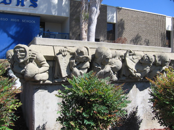Old sculptural figures surround a planter at San Diego High School, near Park Boulevard. They depict academic and athletic endeavors.