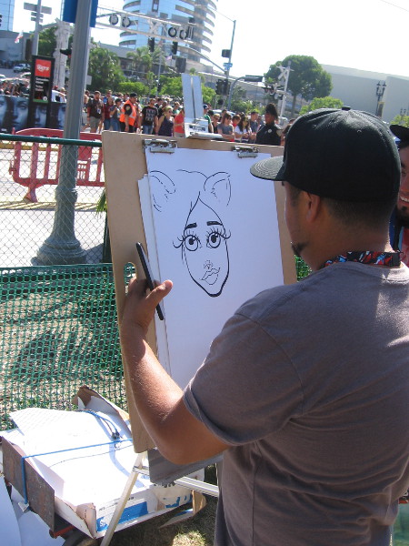 A caricature artist at work on MLK Promenade.