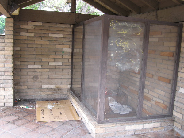 One empty display case, graffiti and a place for the homeless.