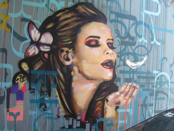 A beautiful female face and a blown feather. If you know who this mural represents, leave a comment!
