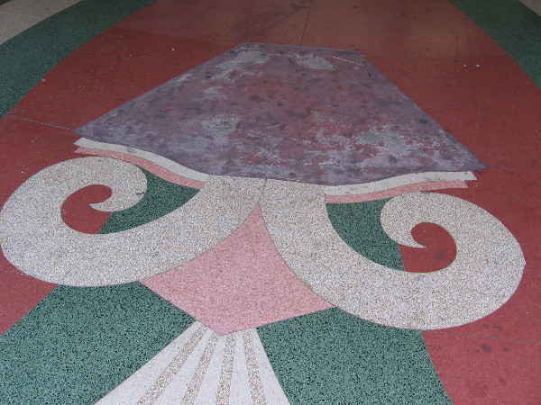 Colorful terrazzo design at entrance to old theater.