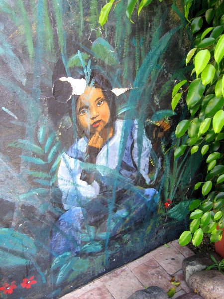 And behind another bush is this human form, sitting among small flowers!