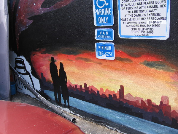 Standing across water from a fiery skyline.