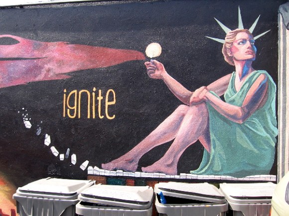 Lady Liberty shines light from atop a piano keyboard. Ignite.