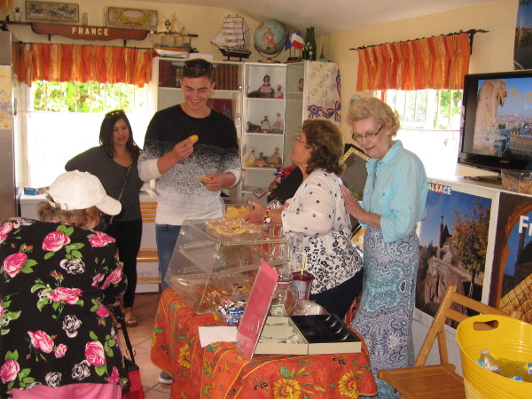 Some visitors inside the House of France sample treats and enjoy more good conversation.