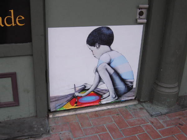 Street art in the Gaslamp shows child making a secret painting.