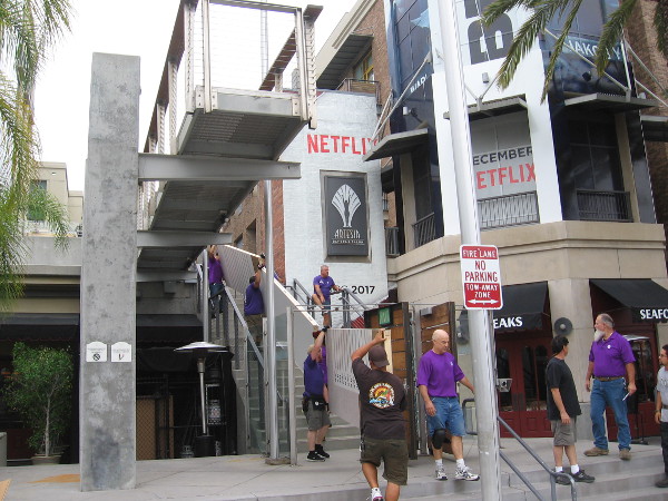 Workers carry stuff into the Hilton Gaslamp, where Netflix is headquartered.