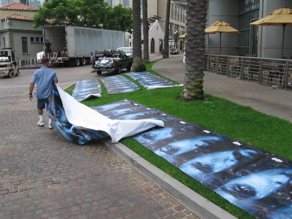 Guys are putting up these long banners promoting HBO's Game of Thrones.
