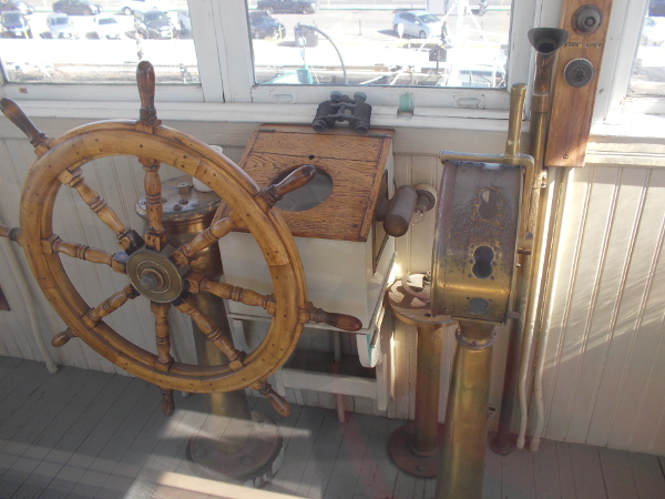 The wooden wheel, binoculars and other instruments used to pilot the ferry.