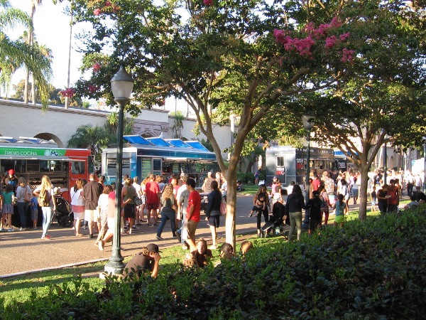 People stroll down El Prado, checking out a variety of gourmet food trucks on a late Friday afternoon.