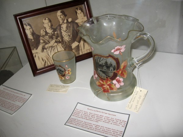 A hand blown and painted glass pitcher and drinking glass that belonged to Maria de Jesus Alvarado de Sepulveda, daughter of Francisco María Alvarado.