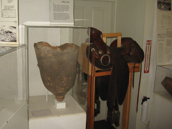 The large earthenware olive jar was found under the ranch house floor during an excavation in 1983. Used for food storage, it was probably made in Spain or Portugal in the early to mid 1700s.