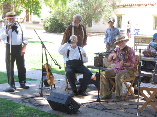 A guitar, fiddle, banjo and a bottle. These frontier musicians were getting ready to provide a bit of Western entertainment.