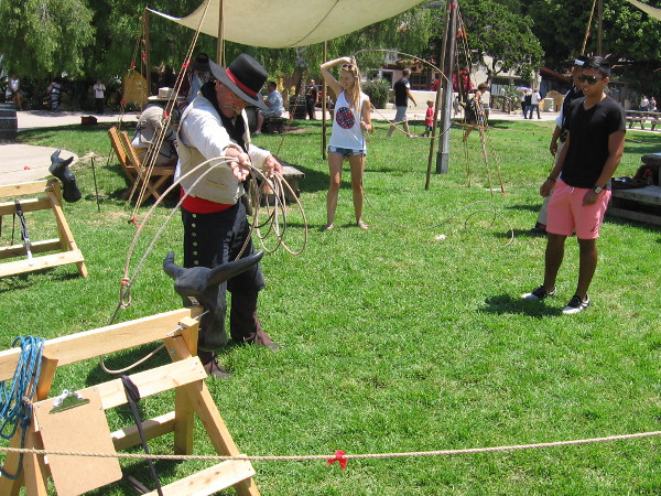 A vaquero shows a visitor to Old Town how to properly handle a rope.