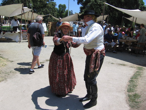 A couple dances to the happy, gentle music.