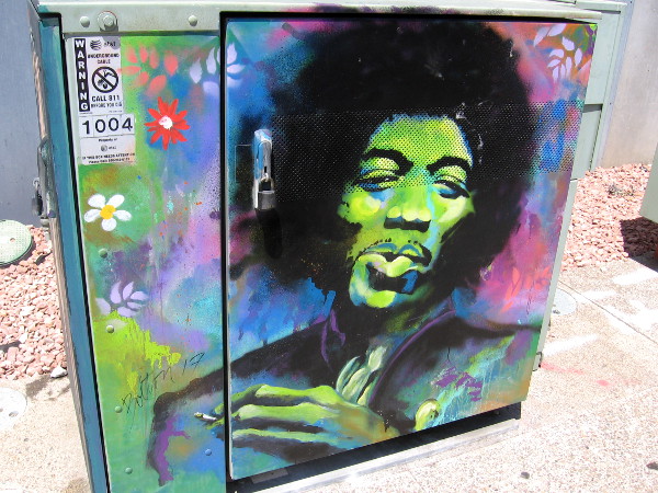 Cool street art in East Village shows a colorful Jimi Hendrix.