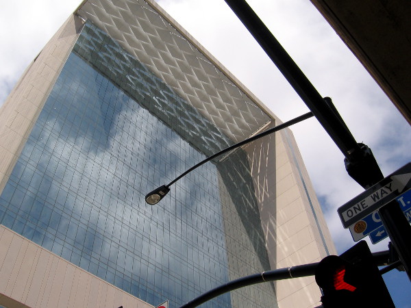 Fascinating reflections and shadows on glass windows beneath a projecting rooftop canopy.