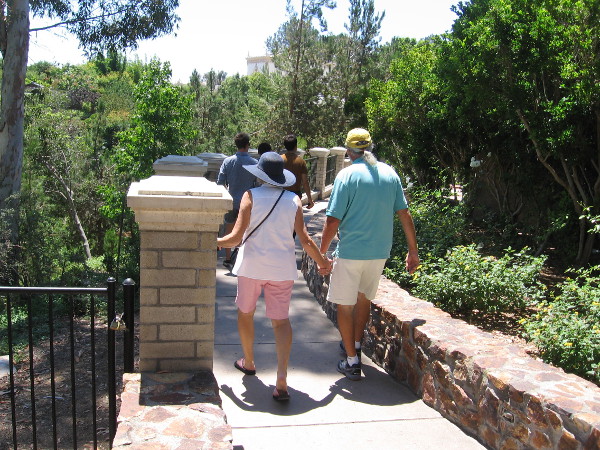 Folks walk down toward the Casa del Rey Moro Garden.