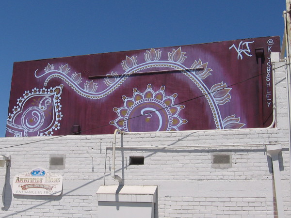 Exotic mural up high in the alley behind Amethyst Moon.