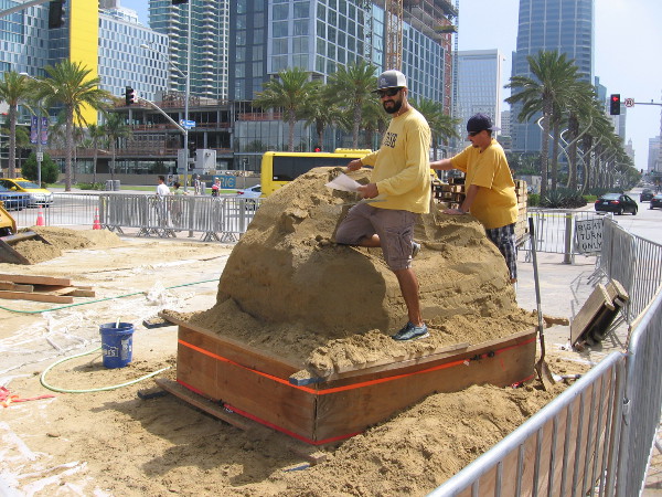 These local sand artists belong to the I.B. Posse. They're working on a sculpture for MTS that will include San Diego's skyline.