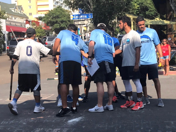 Tampa Chargers huddle up during the 2017 Labor Day Stickball Tournament in Little Italy. Photo by Margie Jones.
