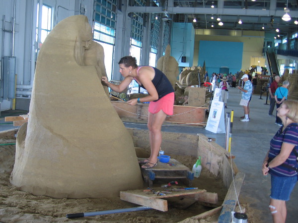 Susanne Ruseler, sand artist from the Netherlands, works on a fine sculpture that juxtaposes youth and old age.
