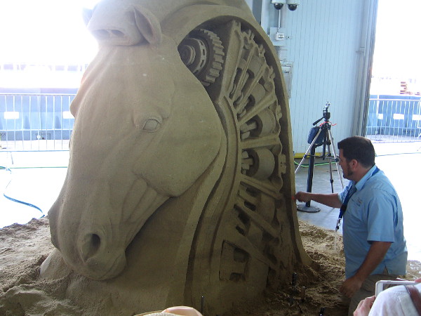 Rusty Croft from Carmel, California is carving an amazing horse's head made of sand.