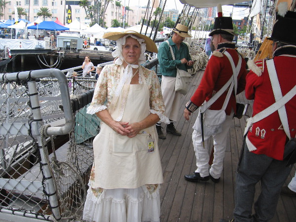 This lady is dressed as a warrant officer's wife. I learned wives of officers often lived aboard British Royal Navy ships in the early 19th century.