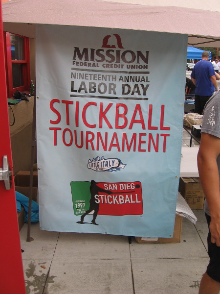 Banner for the Nineteenth Annual Labor Day Stickball Tournament in Little Italy, sponsored by Mission Federal Credit Union.
