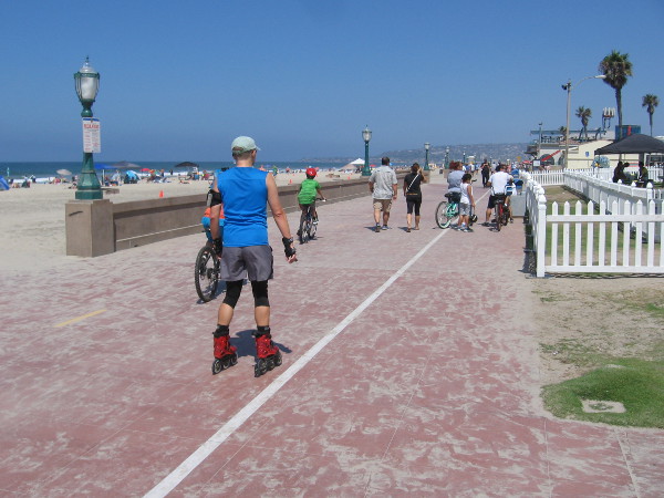 Nearby, on the Mission Beach boardwalk, people are walking, biking and skating by the beautiful blue ocean.