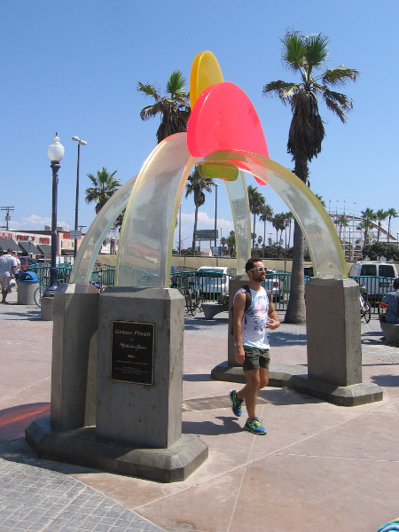 A beachgoer walks under the Green Flash in Mission Beach. I see Belmont Park's Giant Dipper roller coaster in the background.