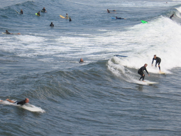 Below the pier, there seemed to be as many surfers as mackerel in the ocean.