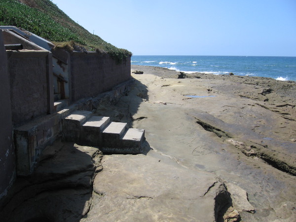 We've passed the Plunge, which is officially part of the beach, and are now carefully traversing sandstone rocks along the base of cliffs. It can be very slippery.