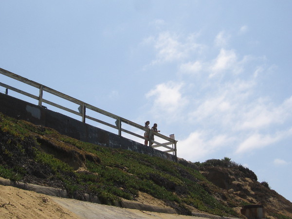 People peer down at us from the street level high above.