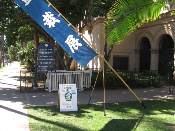 A sign outside the Casa del Prado directs visitors to an exhibition by the San Diego Bonsai Club.