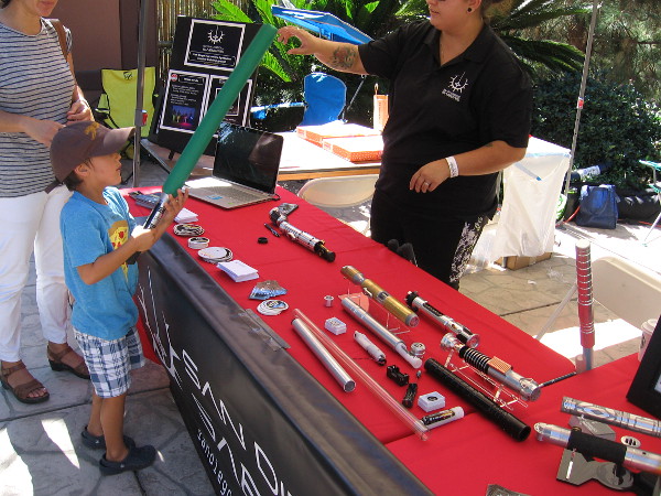 A kid checks out one of the cool lightsabers. As you might have noticed, I took these photos on two different days during Maker Faire San Diego.
