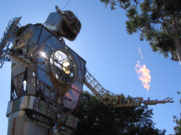Flames rise from the fingertips of Robot Resurrection at 2017 Maker Faire San Diego in Balboa Park.