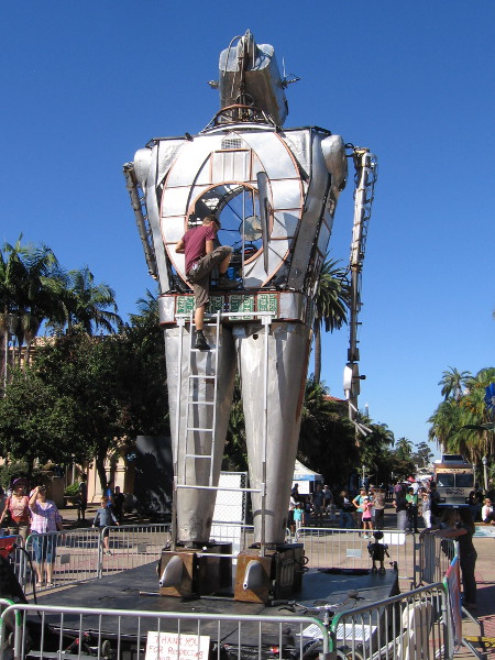 A human operator emerges from the chest of the gigantic flame-throwing robot!