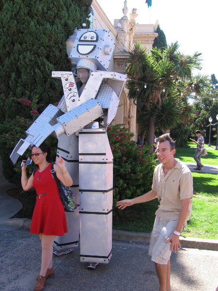 A performance artist becomes a fun robot. People walking down El Prado posed for photos!