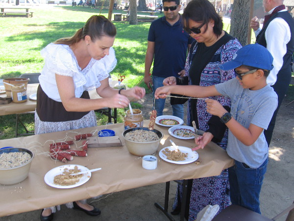 Making environmentally friendly bird feeders using corn cobs, peanut butter and seeds.